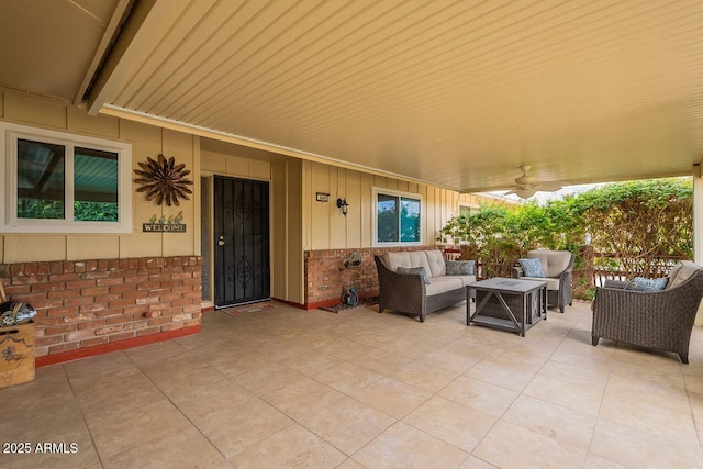 view of patio with an outdoor living space and ceiling fan