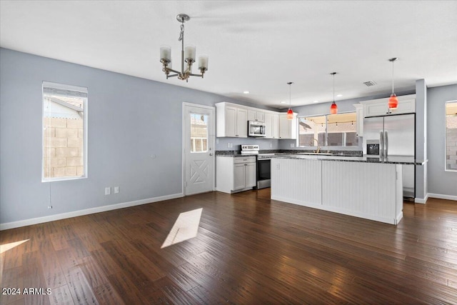 kitchen with stainless steel appliances, a wealth of natural light, and white cabinetry