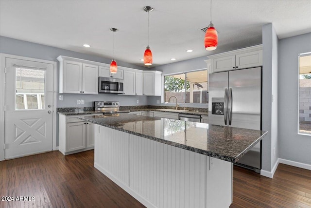 kitchen featuring appliances with stainless steel finishes, a center island, and white cabinetry