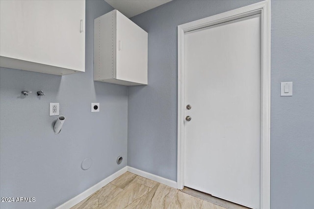 washroom featuring hookup for a gas dryer, hookup for an electric dryer, and cabinets