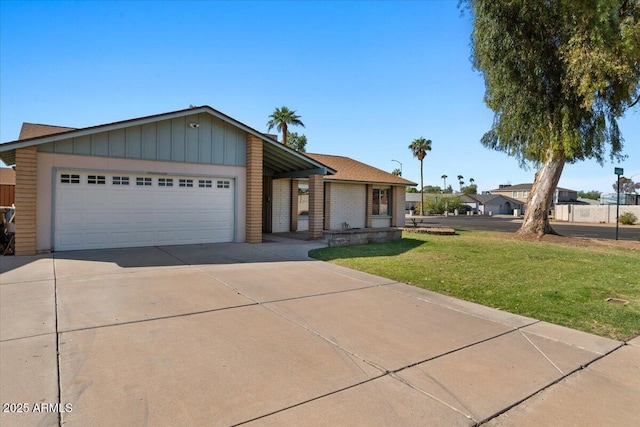 ranch-style house with fence, brick siding, a garage, a front yard, and concrete driveway