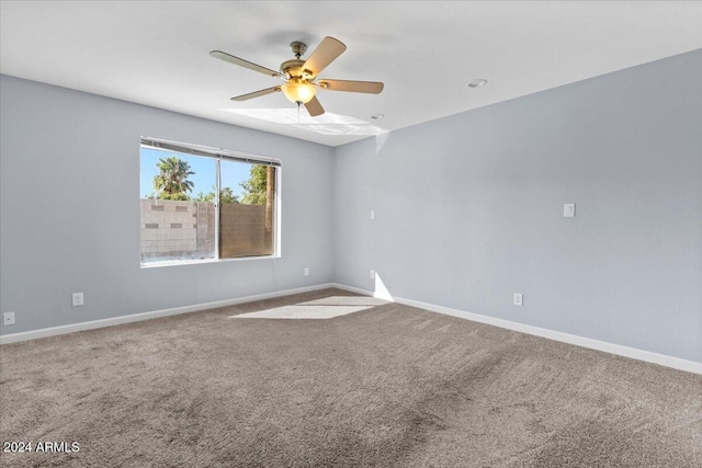 unfurnished room with ceiling fan and carpet flooring