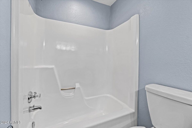 bathroom with shower / tub combination and toilet