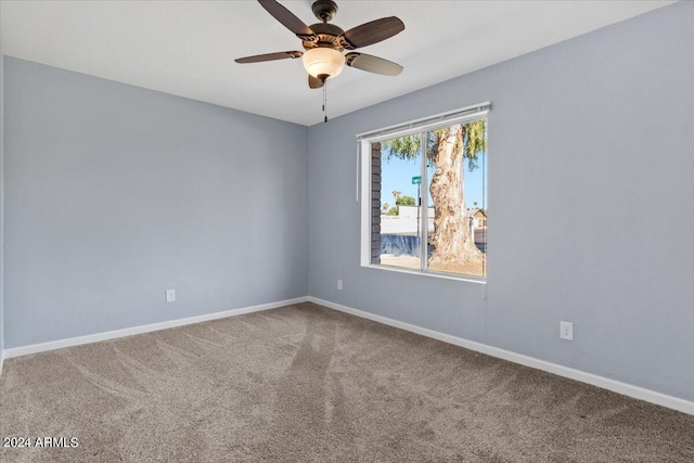 spare room featuring ceiling fan and carpet