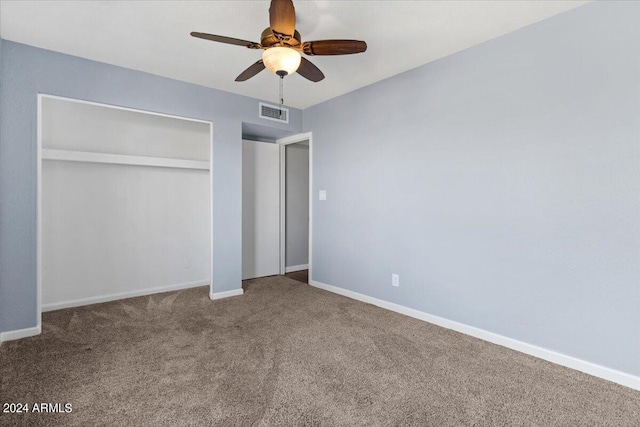 unfurnished bedroom featuring ceiling fan, a closet, and carpet flooring