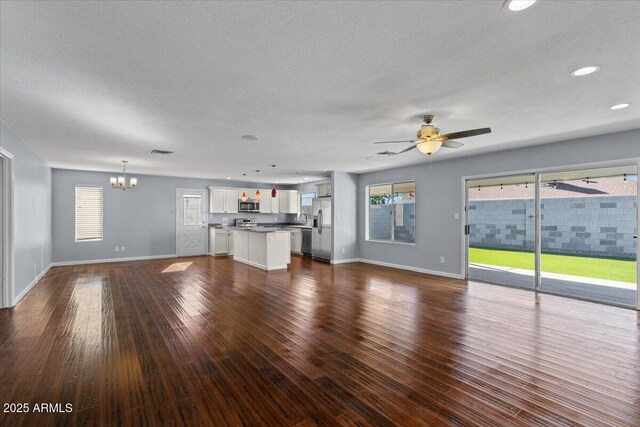 single story home featuring an attached garage, concrete driveway, brick siding, and a front yard