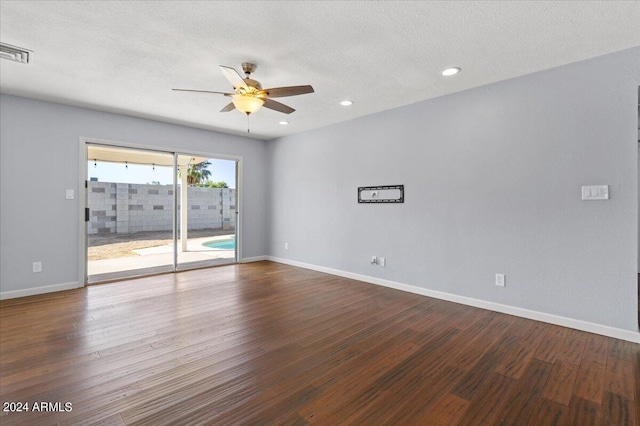 spare room with ceiling fan, a textured ceiling, and hardwood / wood-style floors