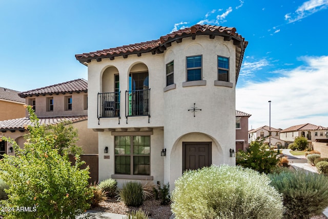 mediterranean / spanish home with a balcony