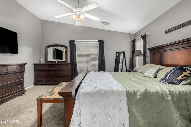 bedroom with ceiling fan, lofted ceiling, and light carpet