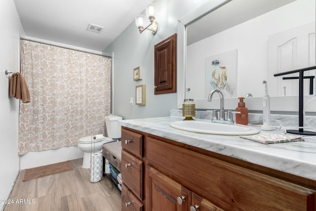 bathroom with vanity, hardwood / wood-style flooring, and toilet