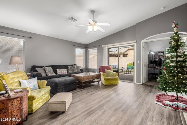 living room with ceiling fan, wood-type flooring, and lofted ceiling