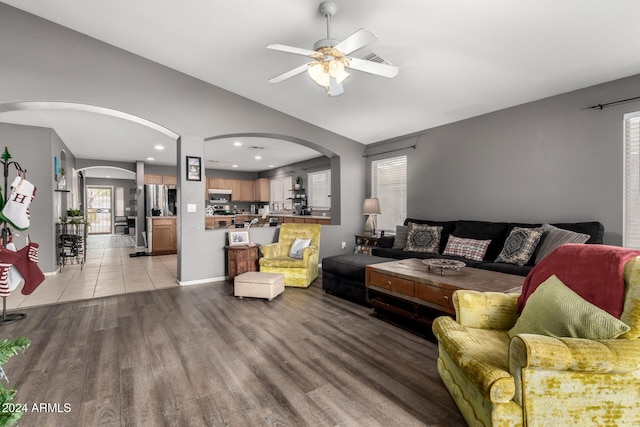 living room featuring light hardwood / wood-style flooring and ceiling fan