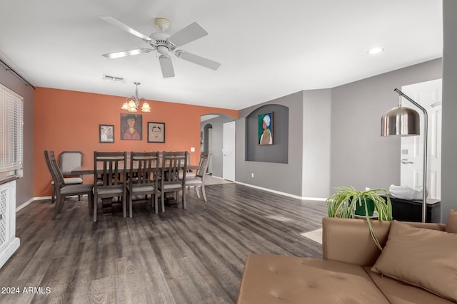 dining room featuring dark hardwood / wood-style flooring and ceiling fan with notable chandelier