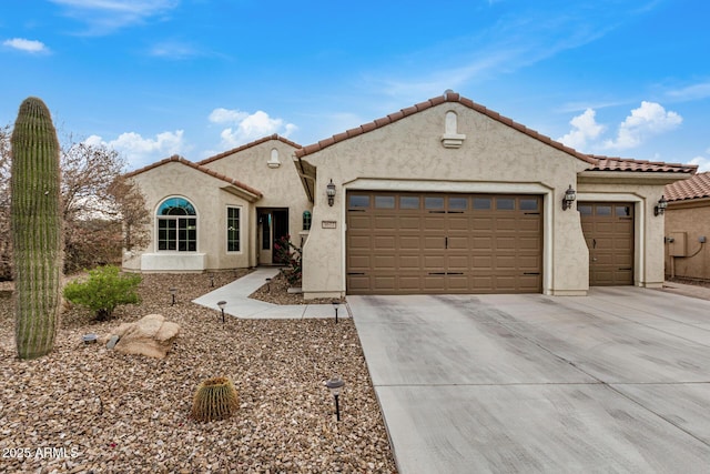 mediterranean / spanish-style home featuring a garage