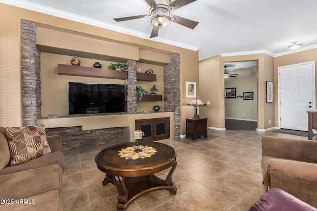 living room featuring ceiling fan, a fireplace, and ornamental molding