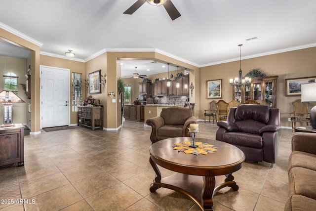 tiled living room with crown molding and ceiling fan with notable chandelier