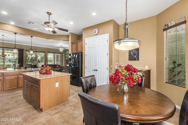 dining space with ceiling fan and sink