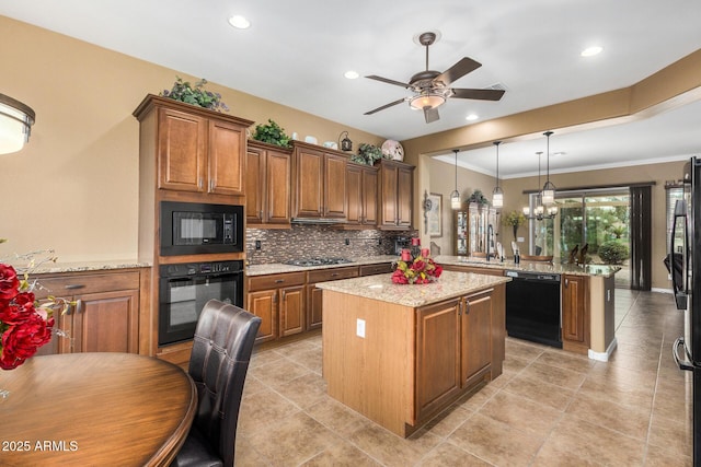 kitchen with a center island, pendant lighting, black appliances, and kitchen peninsula