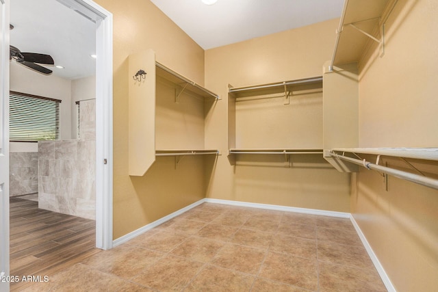 walk in closet with ceiling fan