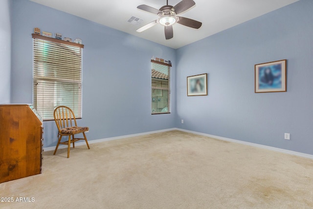 unfurnished room with ceiling fan and light colored carpet