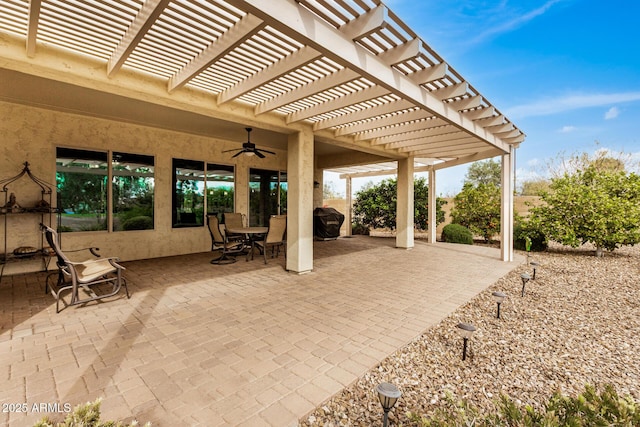 view of patio with ceiling fan, a pergola, and a grill