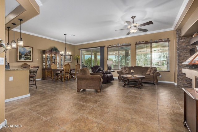 living room featuring a fireplace, a healthy amount of sunlight, ceiling fan with notable chandelier, and crown molding