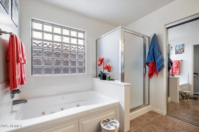 full bathroom featuring a shower stall, a whirlpool tub, and tile patterned floors
