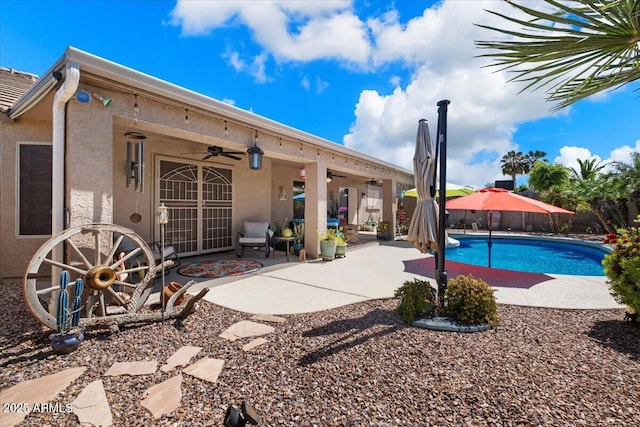 view of pool featuring a ceiling fan, a fenced in pool, fence, and a patio area