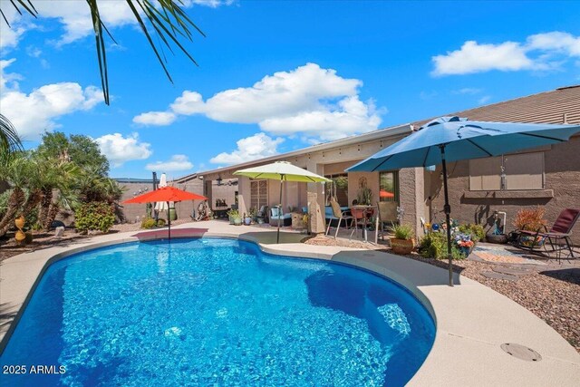outdoor pool with a patio area