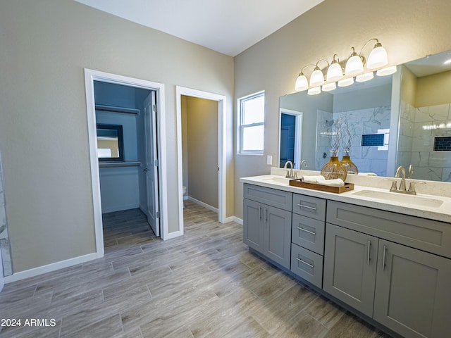 bathroom with vanity and tiled shower