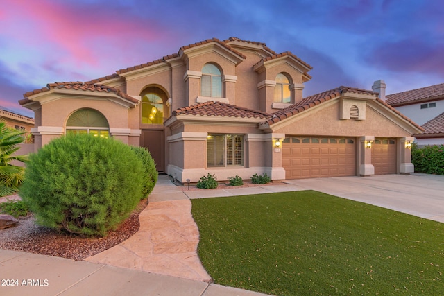 mediterranean / spanish-style home with a garage