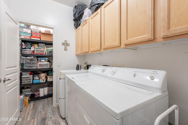 8180 E Shea Blvd Unit 1043, Scottsdale, AZ 85260 - washroom with washing machine and dryer, light wood-type flooring, and cabinet space