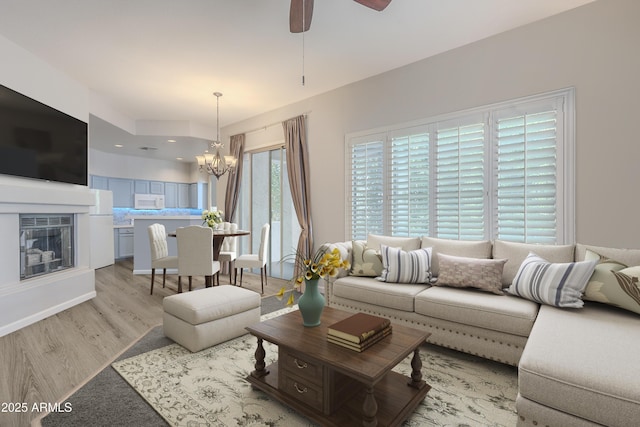 8180 E Shea Blvd Unit 1043, Scottsdale, AZ 85260 - living room featuring a chandelier, light wood-style flooring, ceiling fan, and a glass covered fireplace