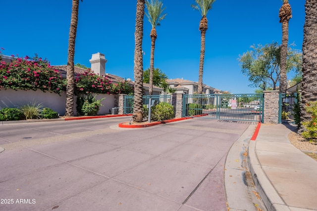 8180 E Shea Blvd Unit 1043, Scottsdale, AZ 85260 - view of concrete road featuring a gate, curbs, a gated entry, and sidewalks