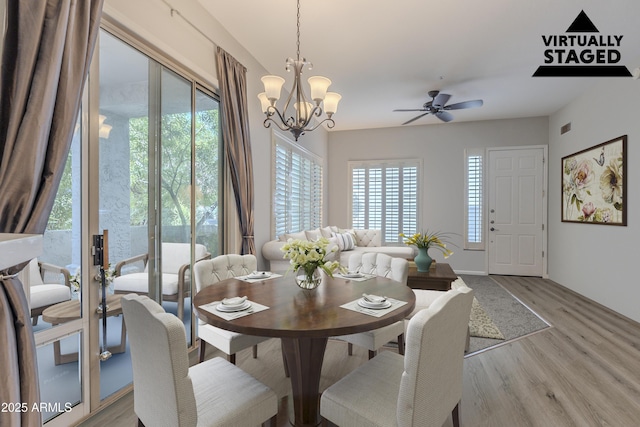 8180 E Shea Blvd Unit 1043, Scottsdale, AZ 85260 - dining room featuring light wood-style flooring, a chandelier, and ceiling fan