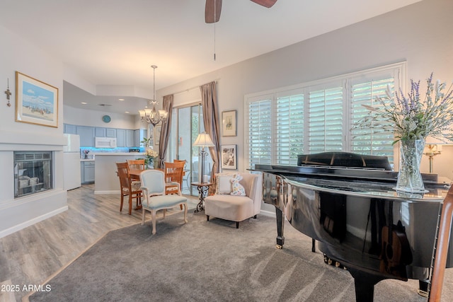 8180 E Shea Blvd Unit 1043, Scottsdale, AZ 85260 - living area featuring a chandelier, ceiling fan, and light wood finished floors