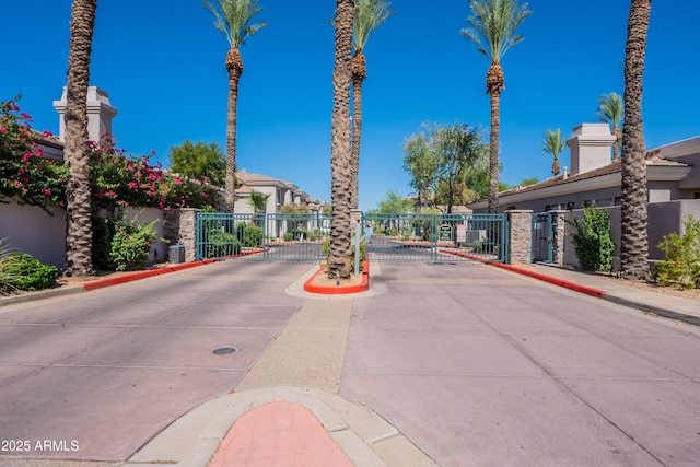 8180 E Shea Blvd Unit 1043, Scottsdale, AZ 85260 - view of concrete road with a gate, curbs, a gated entry, sidewalks, and a residential view