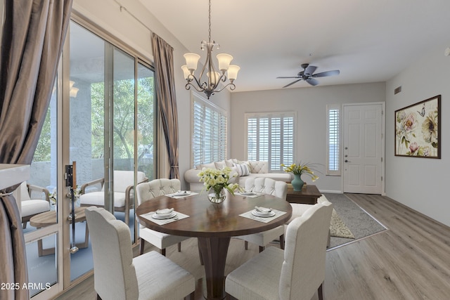8180 E Shea Blvd Unit 1043, Scottsdale, AZ 85260 - dining area with light wood-type flooring, a chandelier, and ceiling fan