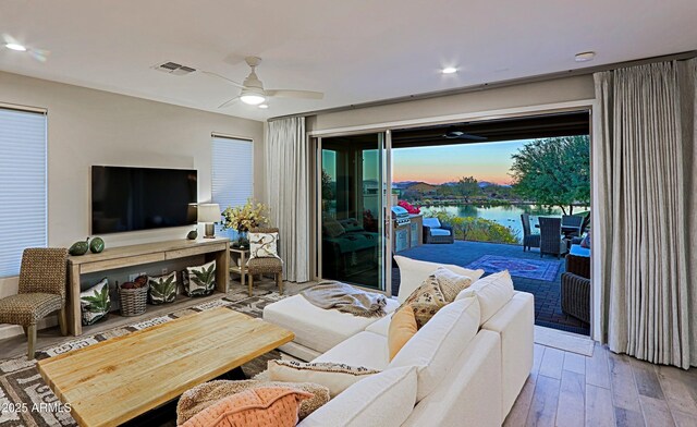 living area featuring recessed lighting, wood finished floors, visible vents, and a ceiling fan