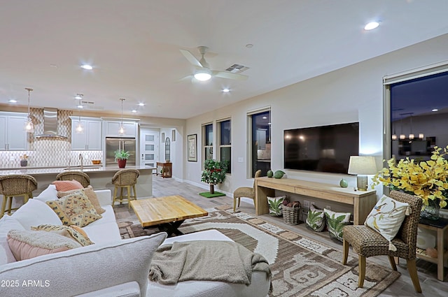 living room with baseboards, recessed lighting, visible vents, and a ceiling fan