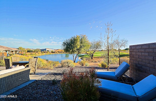 view of patio / terrace featuring a water view and fence