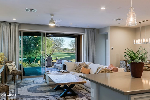 living area featuring ceiling fan, visible vents, and recessed lighting