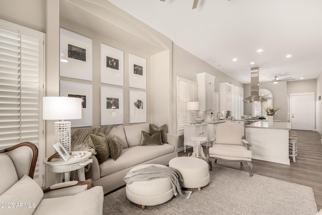 living area featuring baseboards, recessed lighting, ceiling fan, and wood finished floors
