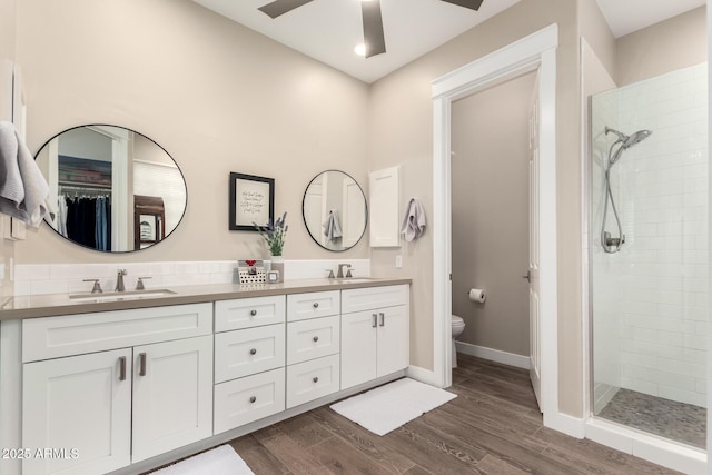 full bath with a sink, a stall shower, and toilet