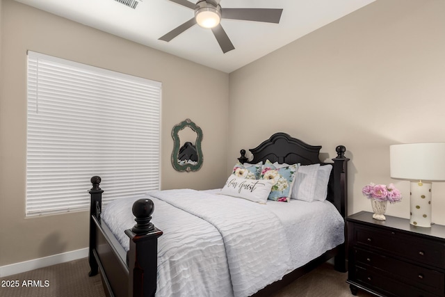 carpeted bedroom featuring baseboards and a ceiling fan