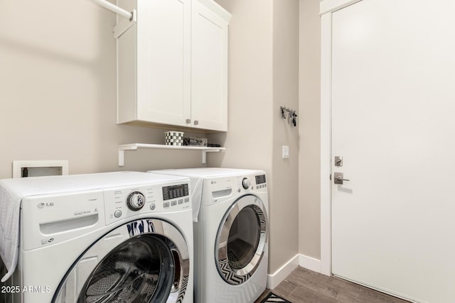 laundry area featuring baseboards, cabinet space, independent washer and dryer, and wood finished floors