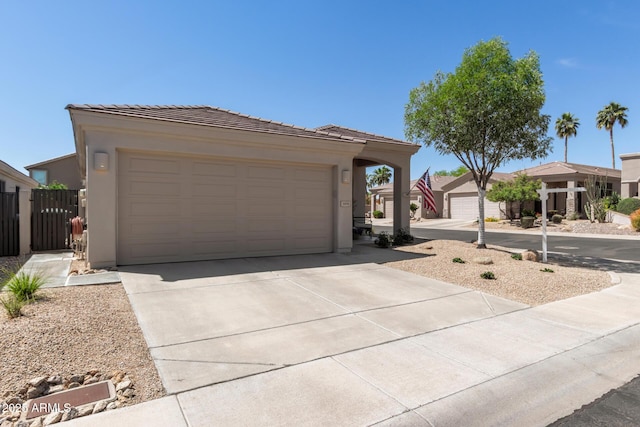 ranch-style home featuring a garage, driveway, a tile roof, and stucco siding