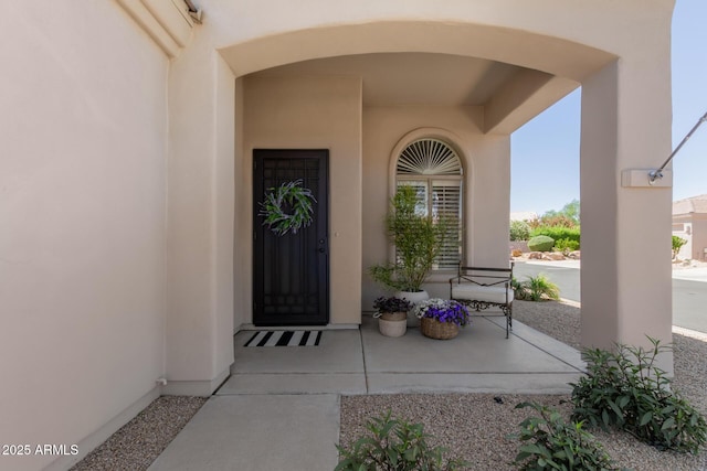 property entrance featuring stucco siding