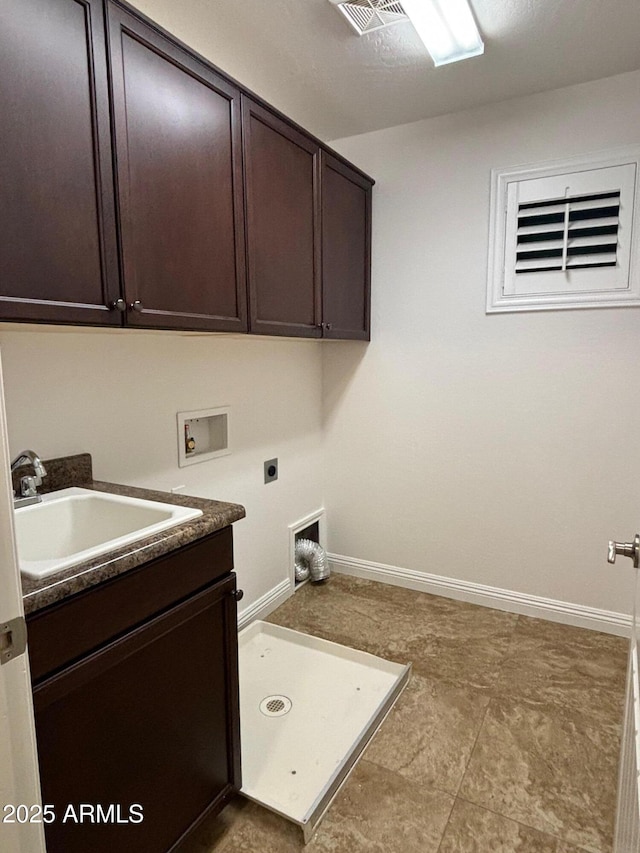 clothes washing area featuring hookup for a washing machine, electric dryer hookup, sink, and cabinets