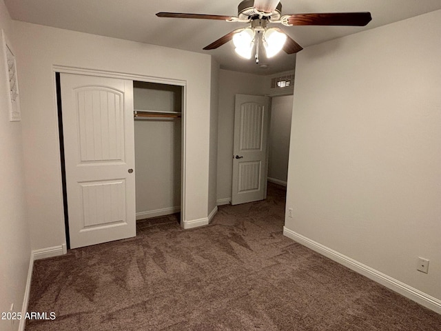 unfurnished bedroom featuring dark colored carpet, ceiling fan, and a closet